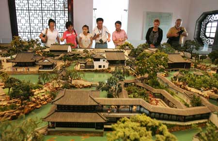 A girl takes photos of the model of the Tiger Hill at the Suzhou Garden Museum in Suzhou City, east China&apos;s Jiangsu Province, May 17, 2009. As the International Museum Day draws near, tourists and local residents came to the new exhibition hall of the Suzhou Garden Museum to know more about history and culture of the famous Suzhou gardens. (Xinhua/Hang Xingwei) 