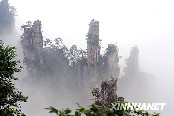 Photo taken on May 15 shows the mountains of Zhangjiajie National Forest Park, the famous tourist destination in central China's Hunan province, hidden in the misty clouds formed after a rainfall, presenting a spectacular scene as in a traditional Chinese brush painting. [Photo:Xinhuanet] 