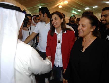  Kuwaiti Rola Dashti (C) is congratulated by her supporters after she and other three female candidates took top positions in three electoral districts in the parliamentary elections in Kuwait City, May 17, 2009. Four women won their first seats during the parliamentary elections held on May 16.