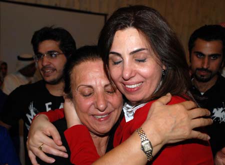 Kuwaiti Rola Dashti (R) is congratulated by her relative after she and other three female candidates took top positions in three electoral districts in the parliamentary elections in Kuwait City, May 17, 2009. Four women won their first seats during the parliamentary elections held on May 16.