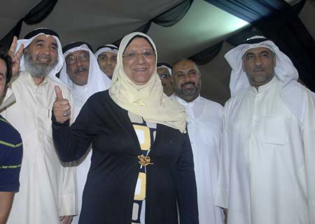 Candidate Massuma al-Mubarak celebrates her victory with supporters in Kuwait City on May 17, 2009. Four women won their first seats during the parliamentary elections held on May 16.