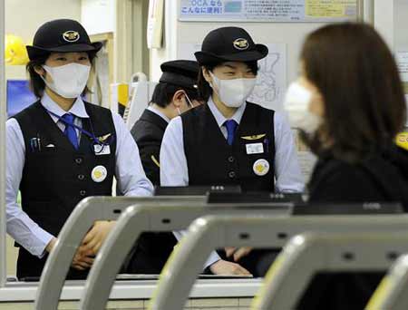  Train station staff in Kobe in western Japan on May 17, 2009. [Xinhua/AFP]