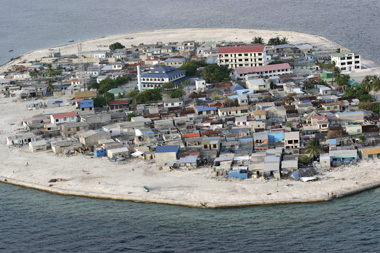 This January 2, 2005, file photo, released by Greenpeace, shows an aerial view of Kandolhudhoo island, Maldives. Members of a US disaster assessment team visited the island where several of its some 3,500 inhabitants died when the 2004 Asian tsunami hit. Scientists have long warned that the Maldives will be wiped out by rising sea levels in the coming decades, but in 2009 some recent data is challenging that dire prediction. [Shanghai Daily]
