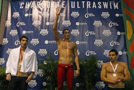Olympic swimming gold medalist Michael Phelps, left, Fred Bousquet, center, and Ricky Berens stand on the podium following the men's final 100-meter freestyle event during the USA Swimming Grand Prix Series Charlotte Ultraswim in Charlotte, N.C., Sunday, May 17, 2009. Phelps finished second to Bousquet, and Berens finished in third place.(Xinhua/Reuters Photo) 