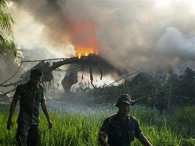 Fire razes through an Indonesian Air Force C-130 cargo plane after it crashed in Magetan, East Java, Indonesia, Wednesday, May 20, 2009.[CCTV/AP Photo] 
