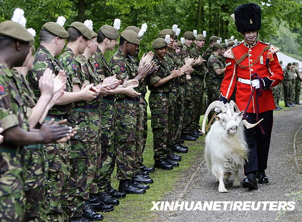 Goat Major L/Cpl Ryan Arthur of the 1st Battalion, The Royal Welsh, leads the regiment's goat William Windsor on his retirement parade. Eight and a half year old 'Billy' was given a full military send off as he headed to Whipsnade Zoo where he will spend the rest of his life.[Xinhua/Reuters] 