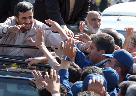 Supporters throw flower petals to greet Iran's President Mahmoud Ahmadinejad, during his visit to Semnan, Iran, Wednesday May 20, 2009. President Mahmoud Ahmadinejad says Iran has test-fired a new advanced missile with a range of about 1,200 miles, far enough to strike Israel and southeastern Europe. The solid-fuel Sajjil-2 surface-to-surface missile is a new version of the Sajjil missile, which Iran said it had successfully tested late last year with a similar range. (Xinhua/AFP Photo)