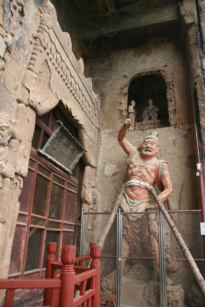 This photo, taken on May 19th, 2009, shows the sculptures and mural paintings found in the Maijishan grottoes. There are 194 existing caves, in which are preserved more than 7,200 sculptures made from terra cotta and over 1,200 square meters of murals. [Photo: CRIENGLISH.com/ Zhao Lixia] 