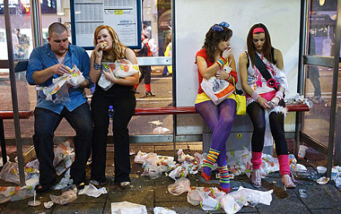 Hungry: Nightclubbers enjoy fast food amid mounds of rubbish after a night on the town. As a seasoned traveller, Maciej Dakowicz was keen to get a few snaps of local life during his stay in Britain. His resulting picture album, however, could do with an X certificate. Taken over a series of Friday and Saturday nights on the streets of Cardiff, the Polish student's images provide a shocking insight into alcohol-fuelled debauchery in the Welsh capital. [Chinanews]