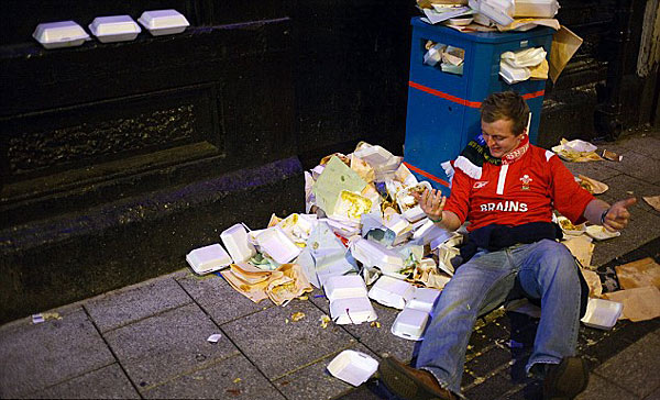 Soft landing: This rugby fan takes a tumble into a pile of discarded take-away cartons [Chinanews.cn]