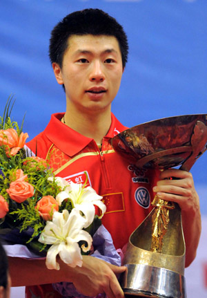 China's Ma Long reacts during the awarding ceremony for the final of men's singles at the 22nd Asian Cup table tennis tournament in Hangzhou, capital of east China's Zhejiang Province, May 21, 2009. Ma Long won the title after beating his compatriot Wang Hao 4-3. (Xinhua/Xu Yu)