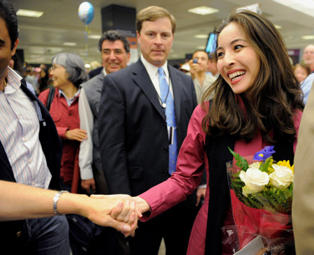 U.S.-Iranian journalist Roxana Saberi(R) is presented with a bouquet of flowers after returning to the United States at Dulles International Airport in Dulles, Virginia. 