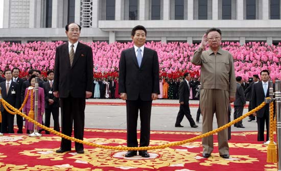 In this Octber 2, 2007, file photo, South Korean President Roh Moo-hyun, center, DPRK leaders Kim Jong Il, right, and Kim Yong Nam, left, inspect honor guards at a welcoming ceremony in Pyongyang. 