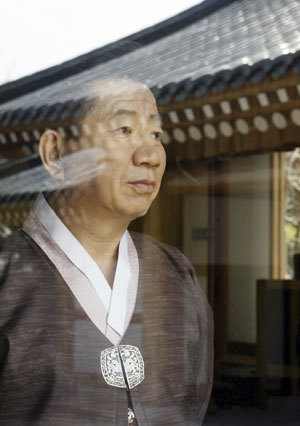 Then South Korean President Roh Moo-hyun looks through the window at the presidential Blue House in Seoul in this April, 2004 photo, after the parliament led by the main opposition Grand National Party impeached him on March 12, 2004.