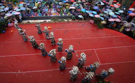 Chinese girls of Miao ethinc minority join in a group dance as they showcase their traditional silver ornament at a gathering in Fenghuang county, central south China's Hunan province, May 23, 2009. The gathering is aimed to promote the culture of China's Miao ethnic minority, especially their tradition of wearing different designs of silver ornament. (Xinhua/Long Tao)