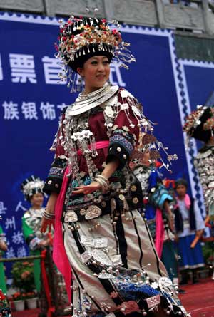 A Chinese girl of Miao ethinc minority joins in a group dance as she showcases the traditional silver ornament at a gathering in Fenghuang county, central south China's Hunan province, May 23, 2009. The gathering is aimed to promote the culture of China's Miao ethnic minority, especially their tradition of wearing different designs of silver ornament. (Xinhua/Long Tao)