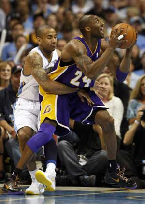 Lakers guard Bryant is fouled by Nuggets guard Jones in the first quarter during Game 3 of their NBA Western Conference final basketball playoff game in Denver