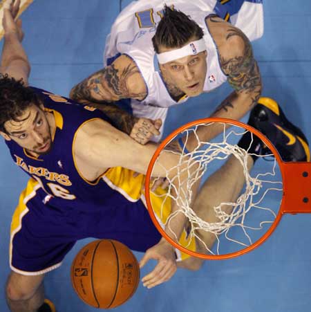 Denver Nuggets center Andersen and Los Angeles Lakers center Gasol look for a rebound in the first quarter of their NBA basketball game in Denver