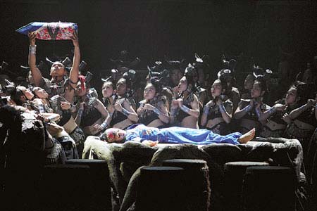 A stage scene reflects the tradition of Yunnan villagers playing the drums to help a woman through labor.