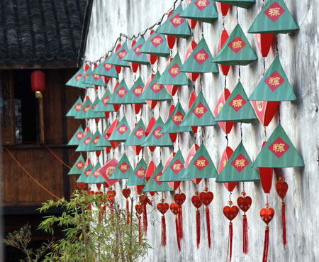 The wall is decorated with Zongzi-shaped lanterns in Jiaxing, east China's Zhejiang Province, May 24, 2009, to celebrate the Chinese traditional Duanwu Festival which falls on May 28 this year. A culture festival with the theme of Duanwu folk custom will be held here from May 26 to 30 in the city.
