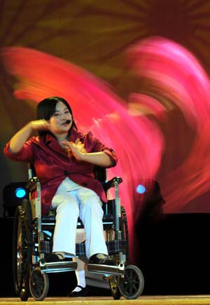 A handicapped artist rehearses on the stage in the Art Performance Center in Liuzhou City of southwest China's Guangxi Zhuang Autonomous Region, on the early morning of May 25, 2009. Dozens of physically disabled artists had a rehearsal against time in the Art Performance Center for the coming 7th Guangxi Joint Performing Art Festival for the Disabled. 