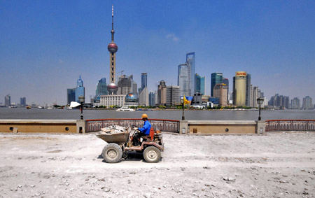 A man works at the construction site along the riverside of the Bund in Shanghai, China, May 26, 2009. The reconstruction project of the riverside along the Bund in Shanghai started recently. The symbolic zone like Huangpu Park, Chenyi Square and etc. are under reconstruction. (Xinhua Photo)