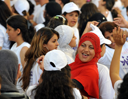  Jewish and Arab women participate in a march in Shfaram, northern Israel, May 26, 2009. Thousands of Jewish and Arab women took part in the march for unity, rights and partnership here on Tuesday. (Xinhua/Yin Bogu)