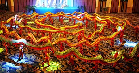 More than 100 men play the dragon dance to mark the Duanwu Festival, also known as the Dragon Boat Festival, at a hotel in Guangzhou, capital city of south China's Guangdong Province, May 28, 2009. The Duanwu Festival falls on May 5 of Chinese lunar calendar. This year's Duanwu festival falls on Thursday.It is generally believed that the Duanwu Festival is marked to remember to Qu Yuan, one of the greatest ancient Chinese poets who drowned himself in the Miluo river to protest the corrupt court. 