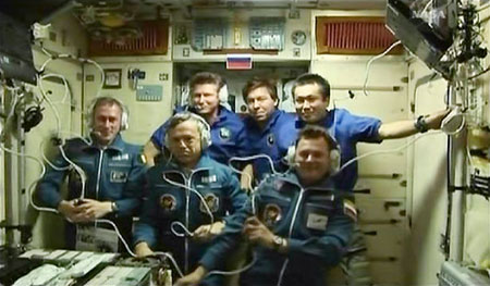 The crew of the Soyuz TMA-15 and the International Space Station (ISS) gather during a news conference in the Zvezda service module following the docking of the two spacecraft in this image from NASA TV May 29, 2009.