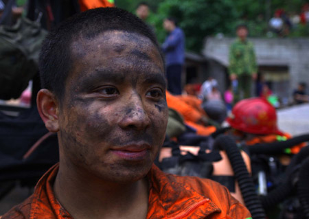 A rescuer rests after a search operation at Tonghua Coal Mine where a colliery gas burst, in southwest China's Chongqing Municipality, on May 30, 2009. The accident has killed 30 and injured 59 miners.