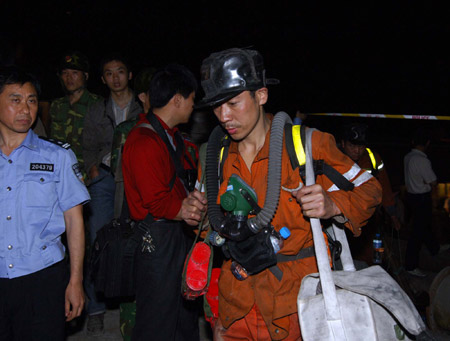 A rescuer walks by the entrance to a coal mine where a colliery gas burst at Tonghua Coal Mine in southwest China's Chongqing Municipality, on May 30, 2009. The accident has killed 30 and injured 59 miners.