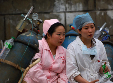 Medics arrive at the entrance to a coal mine where a colliery gas burst at Tonghua Coal Mine in southwest China's Chongqing Municipality, on May 30, 2009. The accident has killed 30 and injured 59 miners.