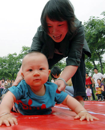 Parents and their babies take part in an amusing sports meet at hte Qingchun Square in Shangyu City, east China's Zhejiang Province, May 30, 2009. [Xinhua photo]