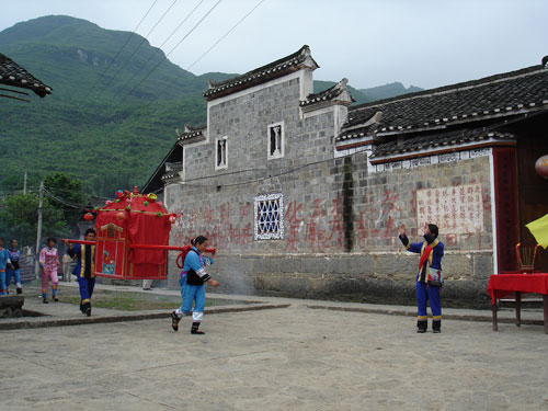 A bride is carried in her sedan chair