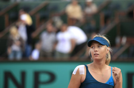 Maria Sharapova of Russia reacts after winning the women's singles fourth round match against Li Na of China at the French Open tennis tournament at Roland Garros in Paris, France, May 31, 2009. Sharapova won 2-1 and advanced to the next round. (Xinhua/Zhang Yuwei)