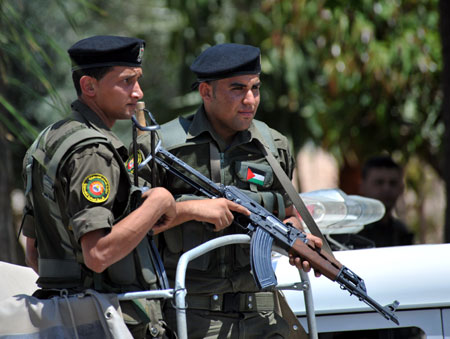 Soldiers of Palestinian National Authority (PNA) security forces guard near the scene where clashes occurred between PNA security forces and armed men from Islamic Resistance Movement (Hamas) in the West Bank city of Qalqilya, May 31, 2009. Three security men loyal to PNA president Mahmoud Abbas, two Hamas militants and the owner of the building where the Hamas gunmen returned to, were killed in the clashes. (Xinhua/Yin Bogu)