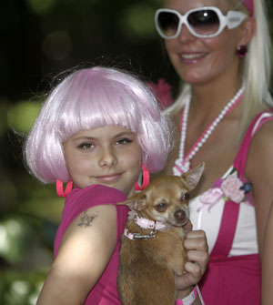 A girl poses with her dog during the 