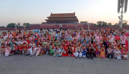 Children pose for photos after attending the flag-raising ceremony at Tiananmen Square in Beijing, capital of China, June 1, 2009. Students from Zhongguancun No.3 Elementary School in Beijing and students of various nationalities from 54 other schools around the country attended the flag-raising ceremony at Tiananmen Square to celebrate the International Children's Day. (Xinhua/Gong Lei)