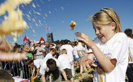 251 children take part in an attempt at the largest custard pie fight at the Kidz Stuff Festival in Horsham, in southern England May 31, 2009. The current record is 120 and the new record is waiting for verification by the Guiness Book of Records.