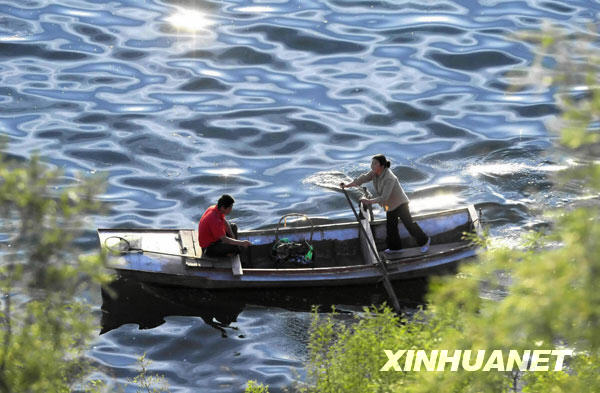 The tranquil water of the Yishui lake in Yi county of northern China's Hebei province is seen in this photo taken on May 29. In the arms of surrounding dark green mountains, the 1,600-hectare lake attracts numerous visitors from nearby cities like Beijing and Tianjin in the early summer. [Photo:Xinhuanet]