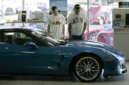 Two automobile enthusiasts look at a 2009 Chevrolet Corvette ZR1, the most expensive and fastest Corvette ever made, at an antique car show which featured cars from General Motors past, present, and future, at the Sport Chevrolet dealership in Silver Spring, Maryland May 31, 2009.