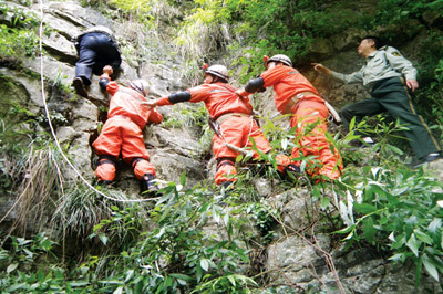 Rainstorm caused turbulent mountain torrents in Anping Village of Dafang County, Guizhou Province, on May 28, 2009. Rescue workers try to save two villagers trapped in the mountain valley. The China Meteorological Administration said the country endured extreme weather in May, with storms in the south and record temperatures in the north.