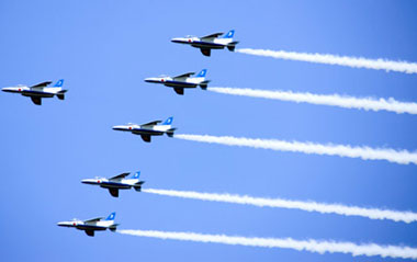 The Blue Impulse aerobatics team of Japan's Air Self-Defense Force performs over Yokohama, Kanagawa Prefecture, Japan, June 2, 2009. The aerobatics show was put on to celebrate the 150th port-opening anniversary of Yokohama.