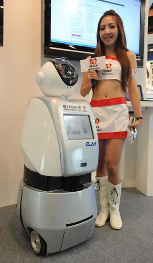 A worker displays a home-keeping robot at COMPUTEX TAIPEI, the world's second largest ICT exhibition, in Taipei of southeast China's Taiwan Province, June 2, 2009. The five-day COMPUTEX TAIPEI was opened on June 2, with the participation of over 1,700 exhibitors. (Xinhua/Wu Ching-teng)