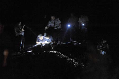 Investigators work at the site where a minitruck crashed into a train near Tianmen, central China's Hubei Province, June 2, 2009. A minitruck crashed with the train K8086 here on Tuesday leaving 9 dead and 9 wounded. (Xinhua/Cheng Min)