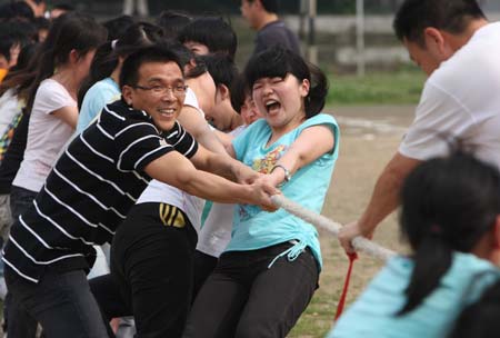 Students of senior 3 of the 5th Middle School of Xiangfan take part in a tug-of-war contest with teachers in Xiangfan City, central China's Hubei Province, June 2, 2009, to release the pressure of facing the forthcoming national college entrance examination. (Xinhua/Liu Tao)