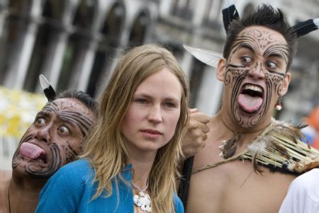 New Zealand artist Francis Upritchard (C) poses with members of traditional Maori group "Waka Huia" in San Marco square, as part of the opening of the New Zealand pavilion at the Venice Biennale June 3, 2009. The Biennale, one of the world