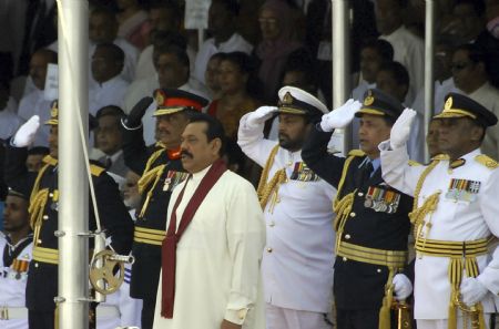 Sri Lankan President Mahinda Rajapaksa (C) stands to attention with commanders of the Sri Lankan military during the National Victory Ceremony in Colombo June 3, 2009.