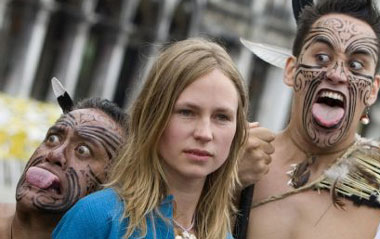 New Zealand artist Francis Upritchard (C) poses with members of traditional Maori group 'Waka Huia' in San Marco square, as part of the opening of the New Zealand pavilion at the Venice Biennale June 3, 2009. The Biennale, one of the world's major art festivals traditionally held every two years dating back to 1895, is open to the public June 7 - November 22, 2009.