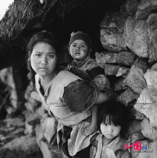 Gu Cailian, 26,with a family of 4 and two acres of land. She earns 100 yuan a year by weaving bamboo baskets, Shanxin village, Yunnan, Nov.2001